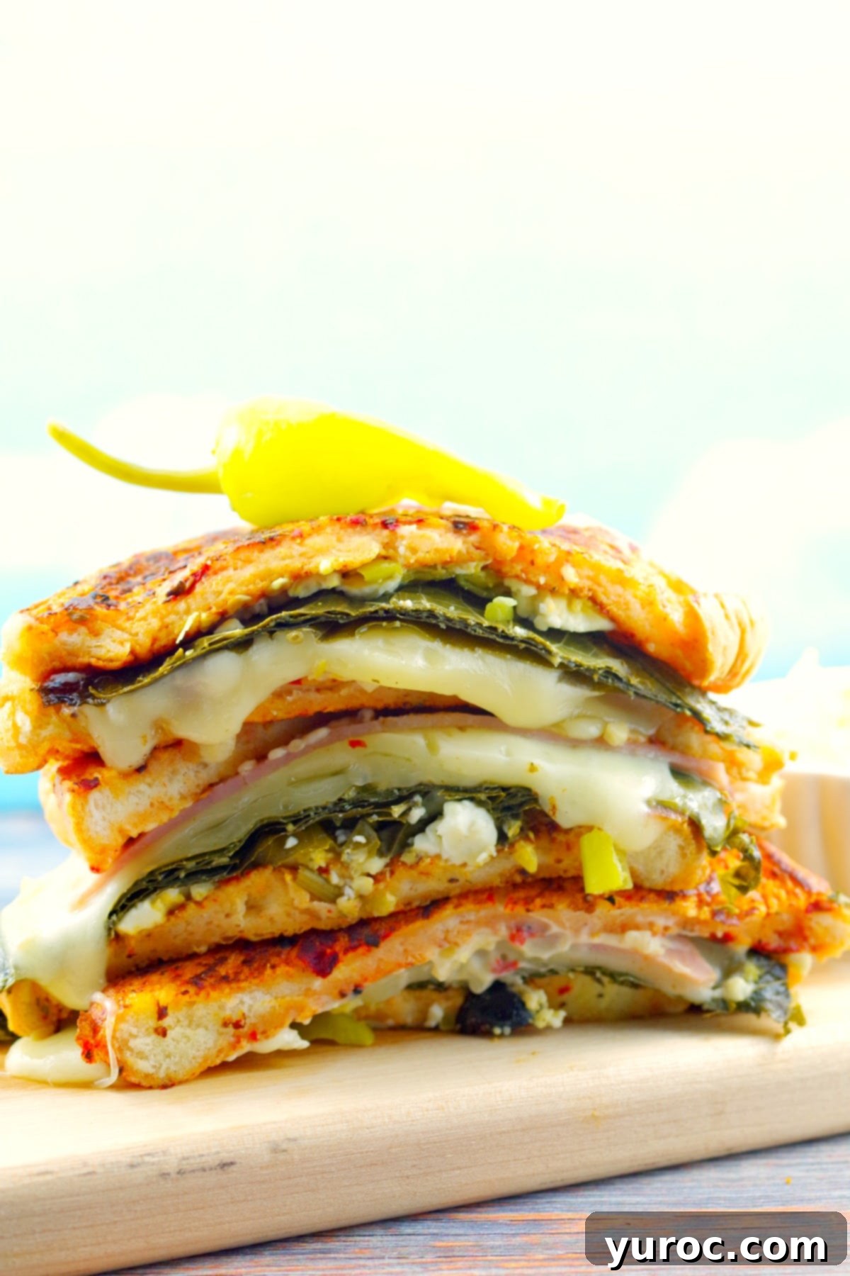 Mediterranean Monte Cristo Sandwich 4 Gourmet Mediterranean Monte Cristo Sandwich presented on a wooden board