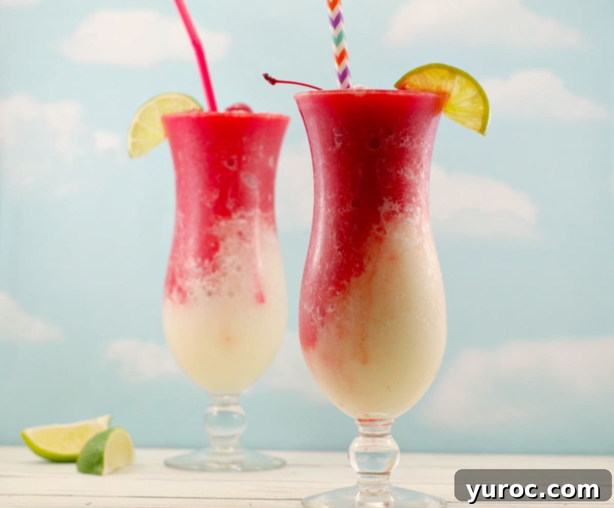 2 Miami Vice Mocktails with straws and lime wedge and cherry garnishes