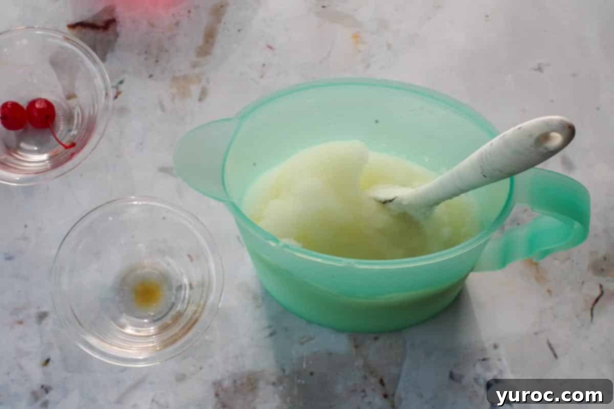 Pina Colada mixture in a blue jug, with a spoon.