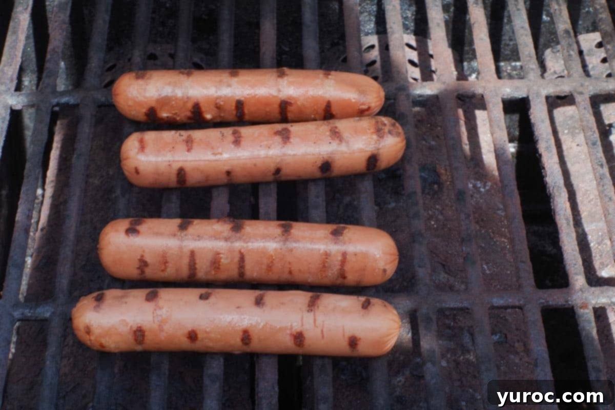 Banh Mi Turkey Hot Dog Twist 5 4 Turkey Hot dogs cooking on the grill, achieving a perfect sear.