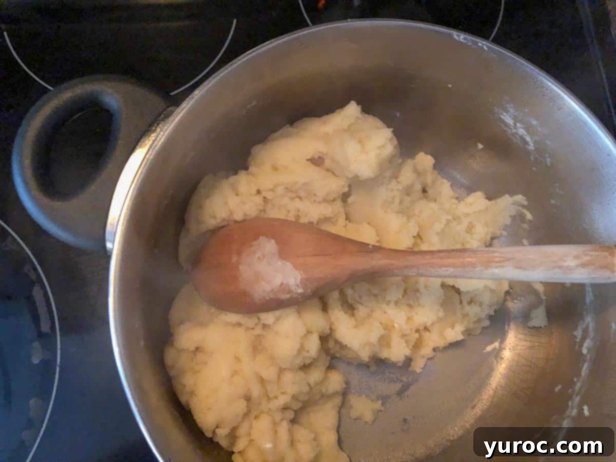 Flour added to boiling water and butter mixture in pot with wooden spoon.