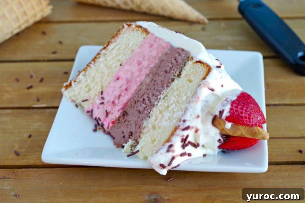 Decadent Neapolitan Ice Cream Cake 5 A perfectly sliced piece of Neapolitan Ice Cream cake on a white plate, showcasing the layered texture of vanilla cake, chocolate ice cream, and strawberry ice cream.
