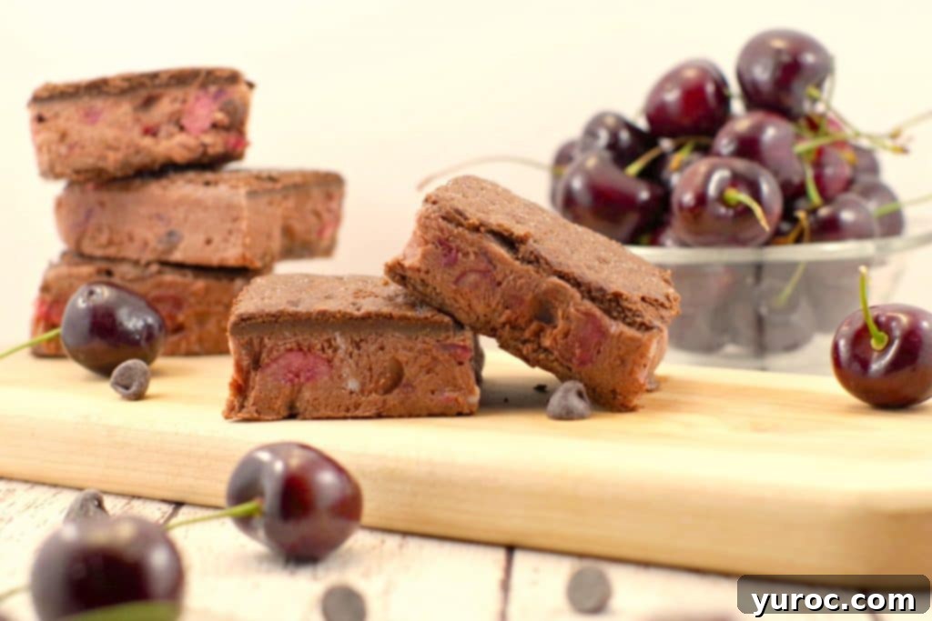Weight Watchers Black Forest Ice Cream Sandwiches neatly arranged on a wooden cutting board, showcasing their rich chocolate color and cherry-infused filling.