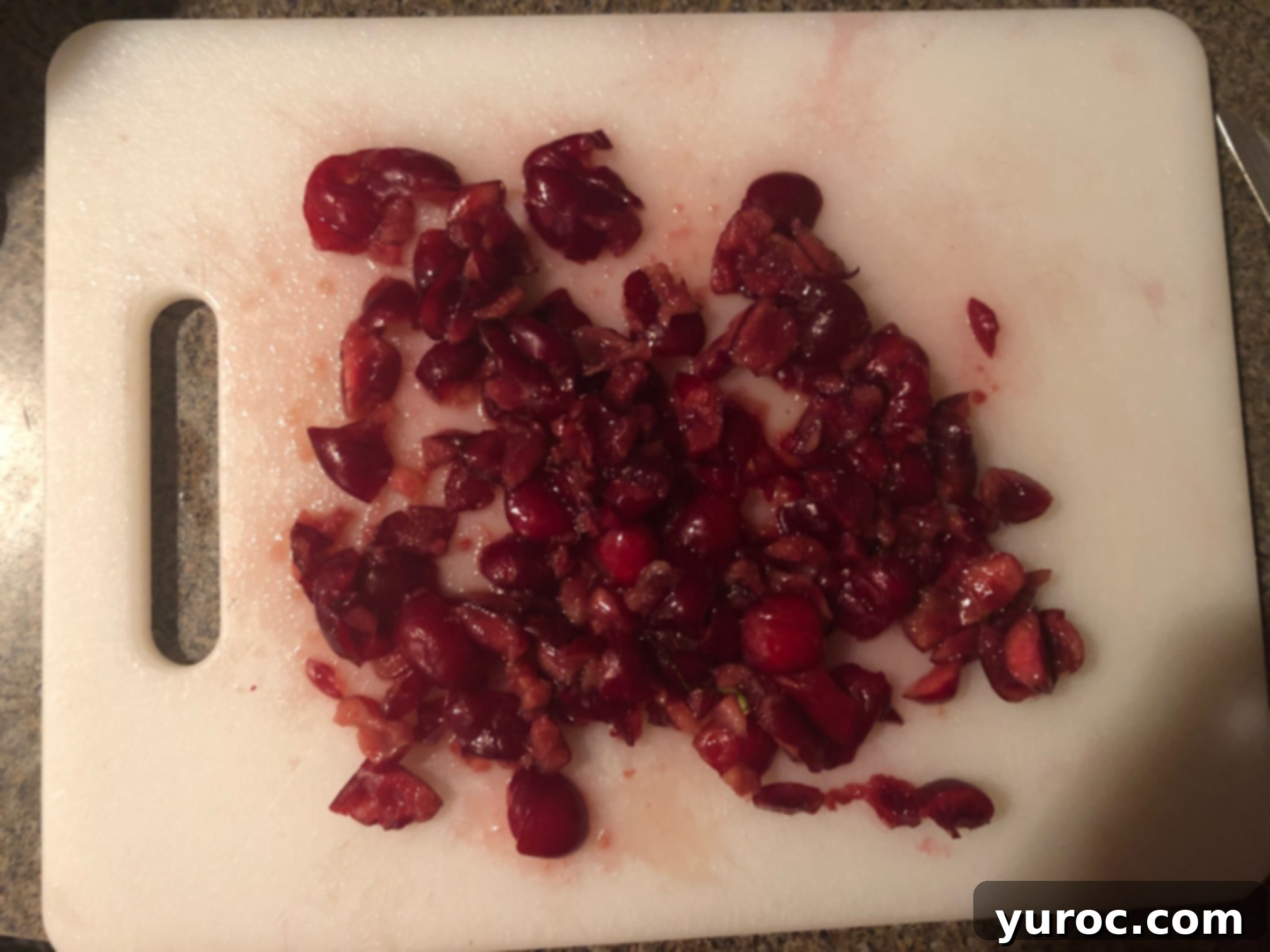 Close-up of freshly chopped dark red cherries, ready for mixing.