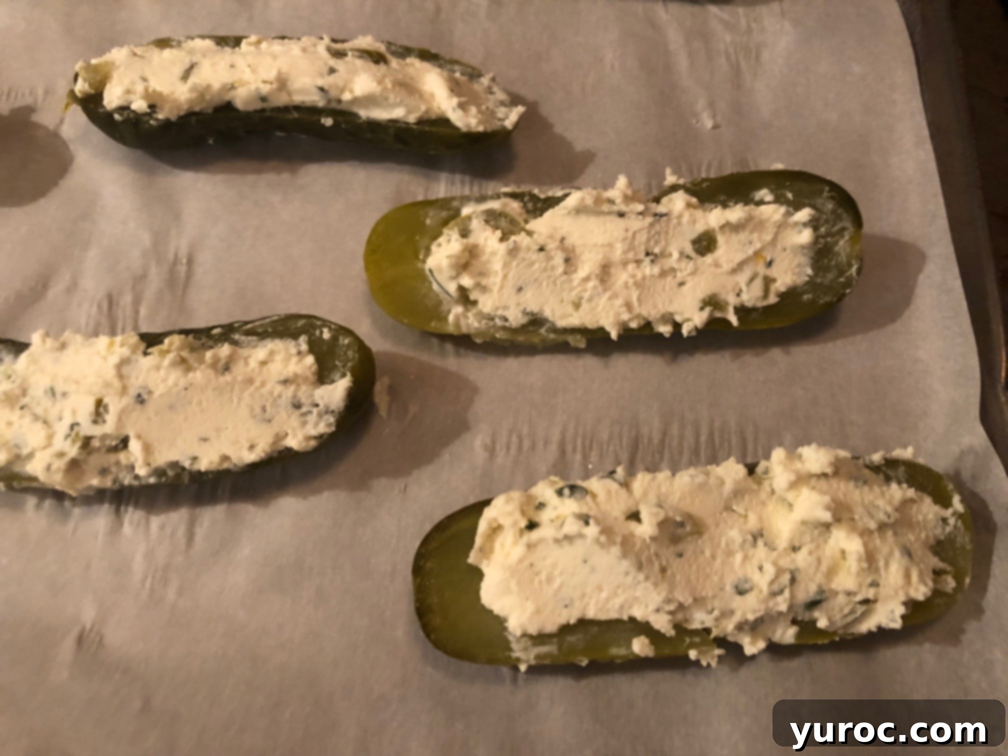 Creamy Boursin Pickle Bites 11 The Boursin cheese mixture smoothed into an even layer within the hollow of a pickle half, creating a neat surface