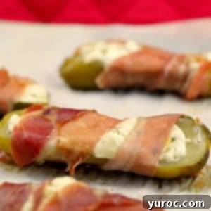 Creamy Boursin Pickle Bites 16 Boursin stuffed pickles on a parchment lined baking sheet