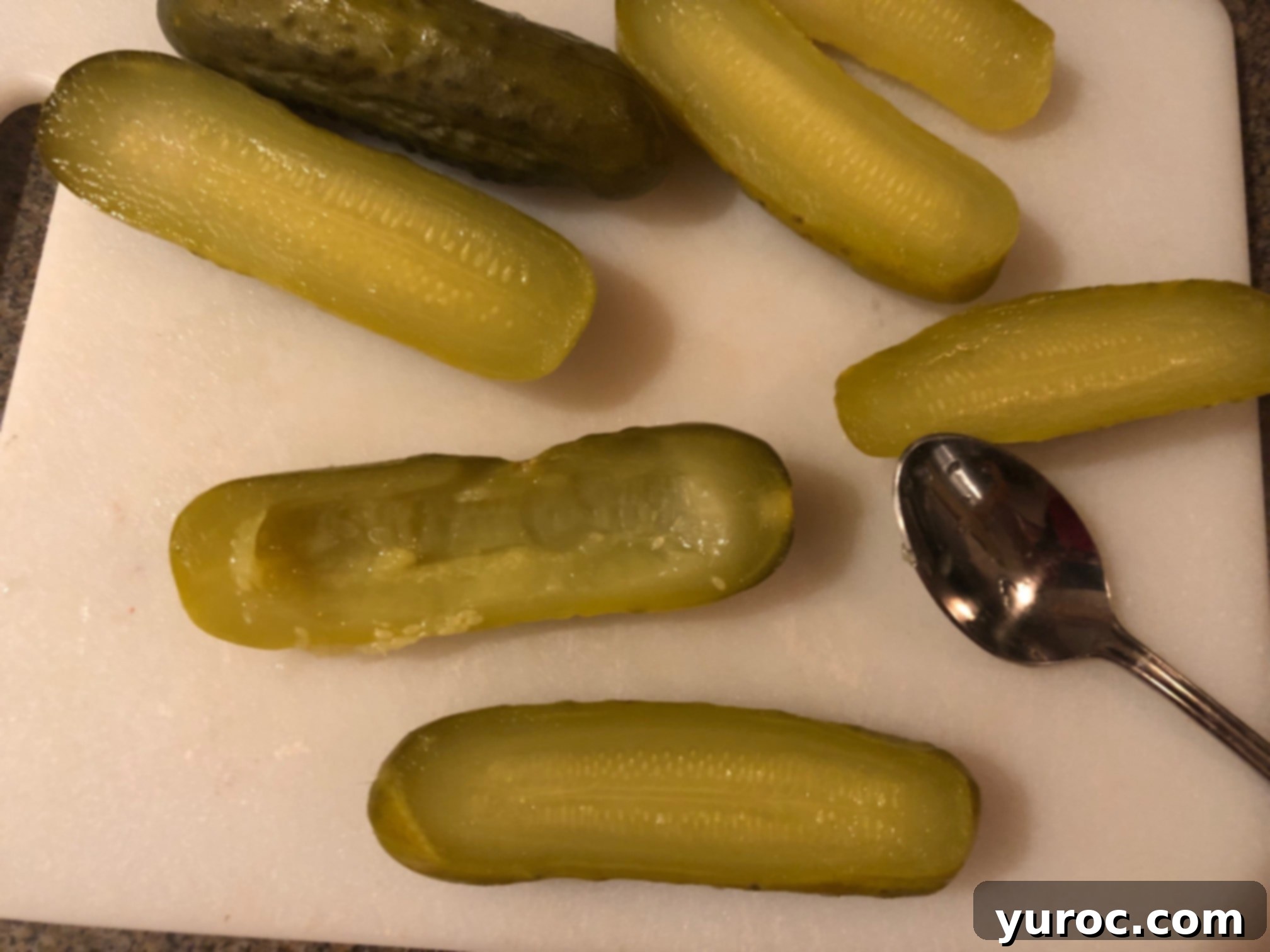 Creamy Boursin Pickle Bites 6 Two hollowed-out pickle halves, showing the ideal depth for the stuffing, retaining enough thickness to prevent breakage