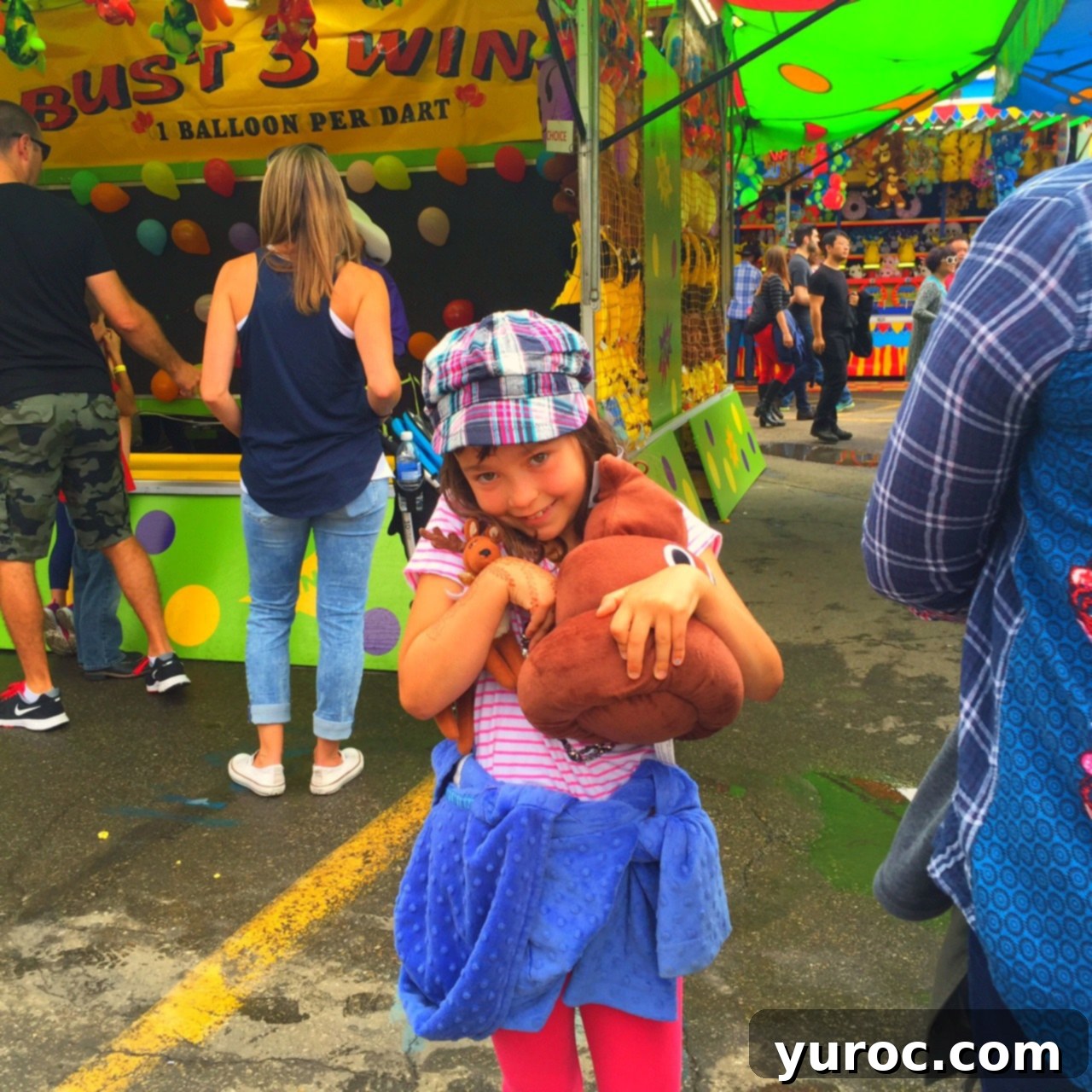 Abby holding a poop emoji prize at Stampede