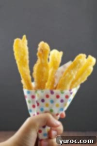 Churros in carnival style colored polka dot paper holder