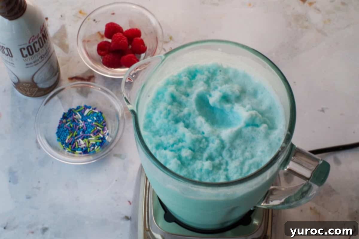 Coconut Blue Raspberry Slushie ingredients fully blended into a smooth consistency in the blender.