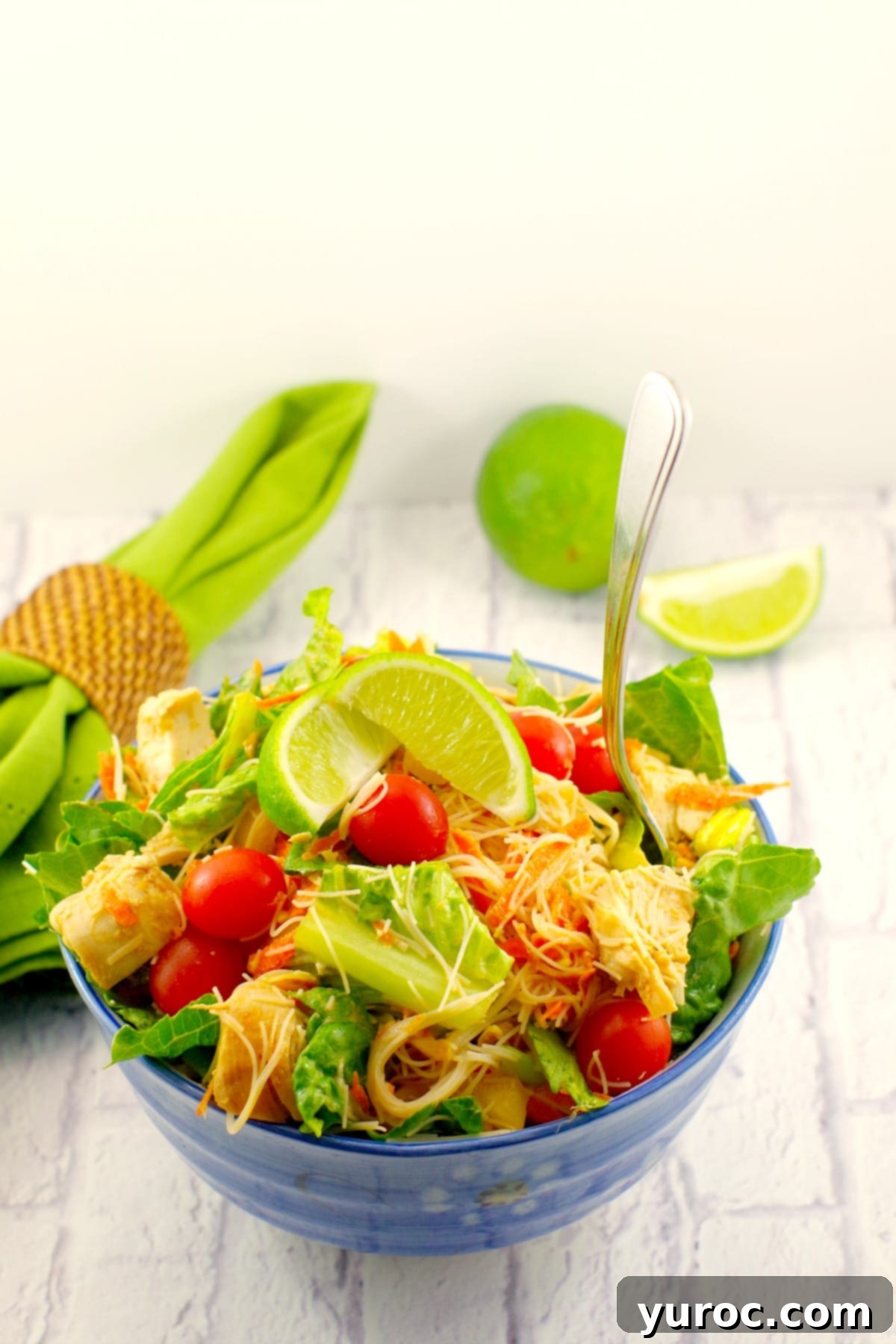 A close-up of Thai chicken salad with peanut lime dressing, highlighting the fresh ingredients and vibrant colors. Easy and healthy recipe from foodmeanderings.com
