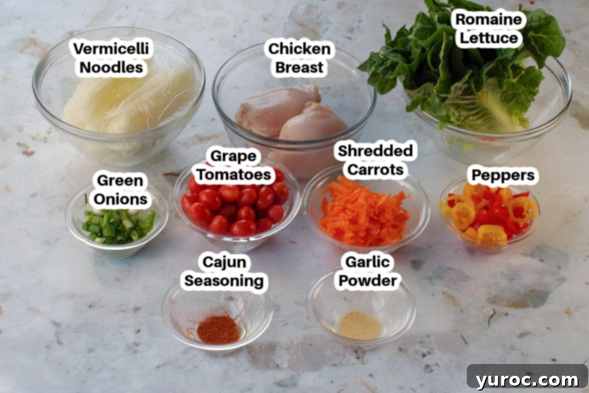 Various fresh vegetables and vermicelli noodles arranged in glass bowls, labeled as salad ingredients.