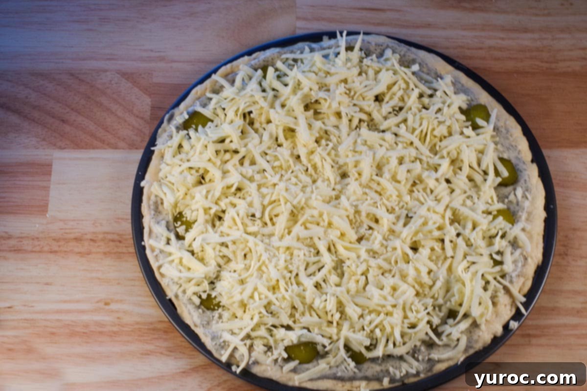 Grated cheese sprinkled over pizza,