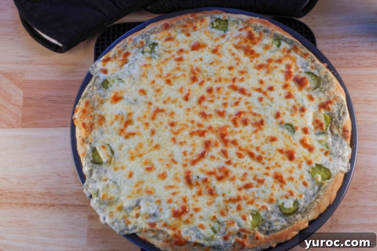 Cooked dill pickle pizza on a trivet