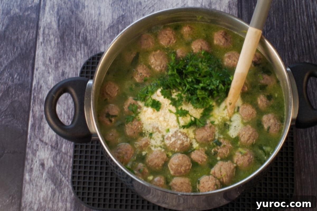Parmesan cheese and parsley added to soup