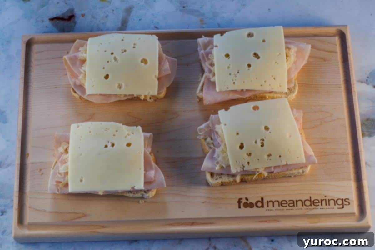 1 slice of Swiss cheese added to turkey and sauerkraut covered bread slice.