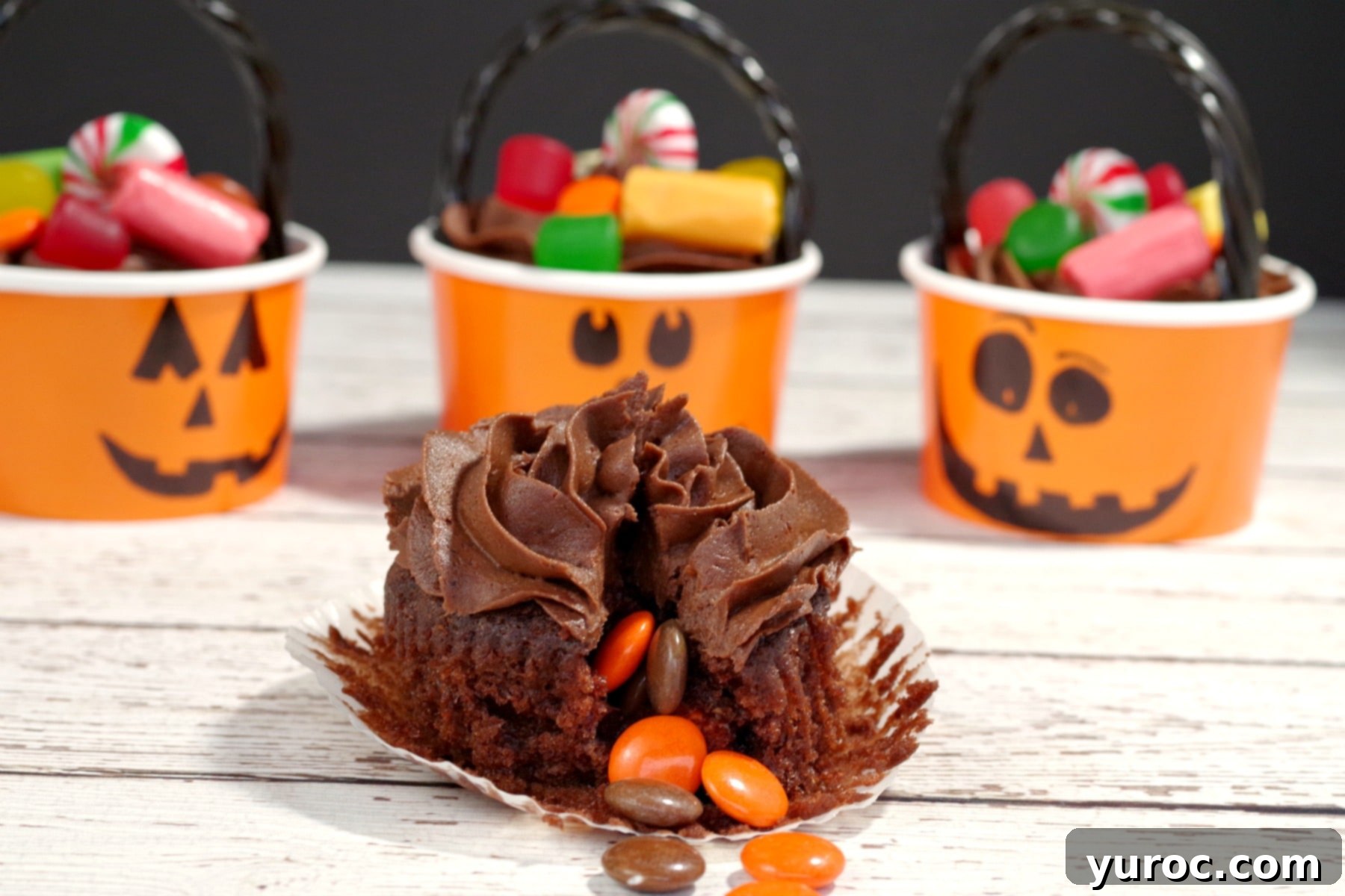 Halloween Pinata cupcake with candy spilling out of cupcake, highlighting the surprise filling