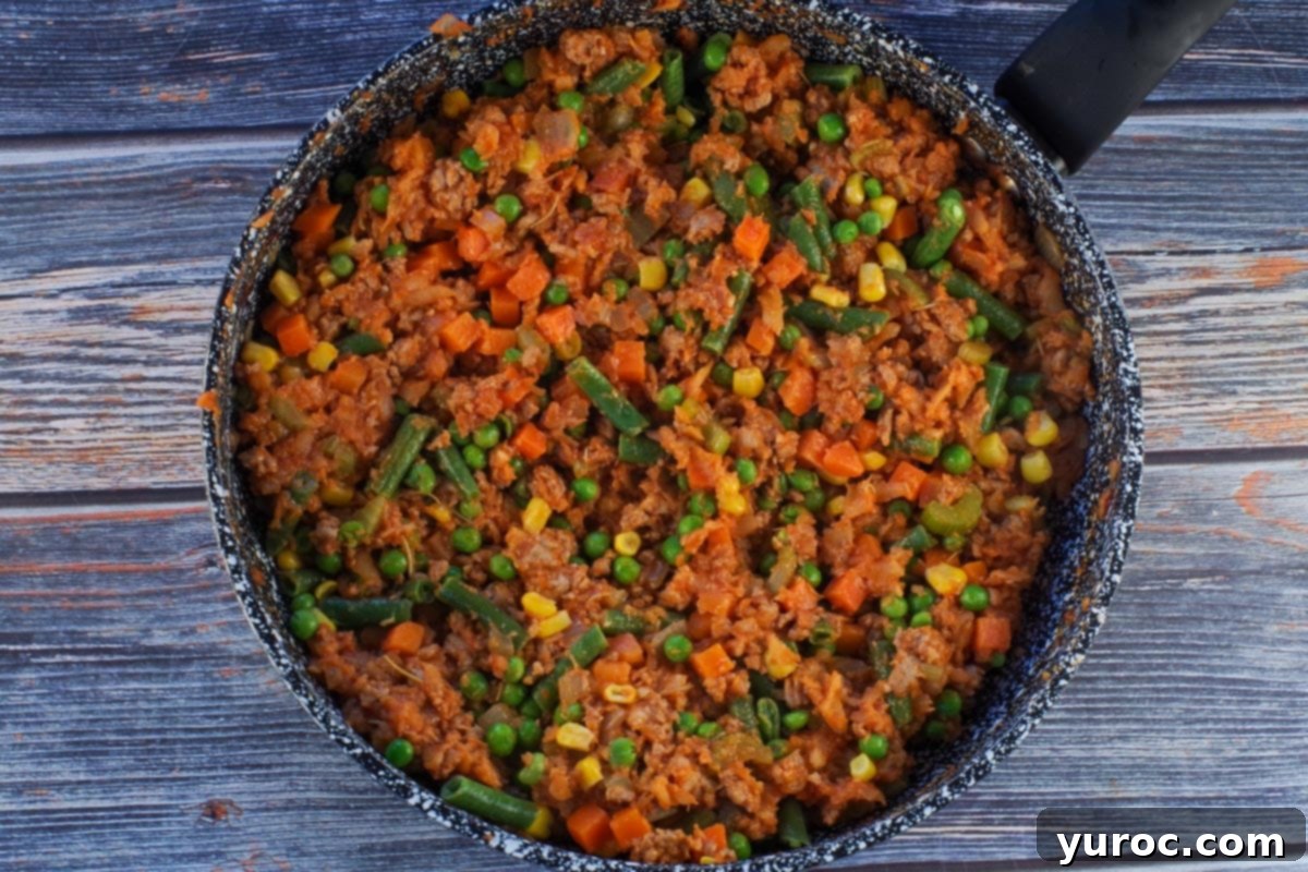 Smart Turkey Shepherd's Pie 8 Turkey, vegetables, tomato paste, flour, Worcestershire sauce, and rosemary combined in a frying pan, simmering into a rich filling.
