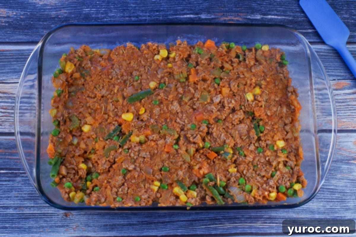 Smart Turkey Shepherd's Pie 9 Turkey meat mixture spread evenly on the bottom of a large 9x13 inch glass baking pan, ready for the potato topping.