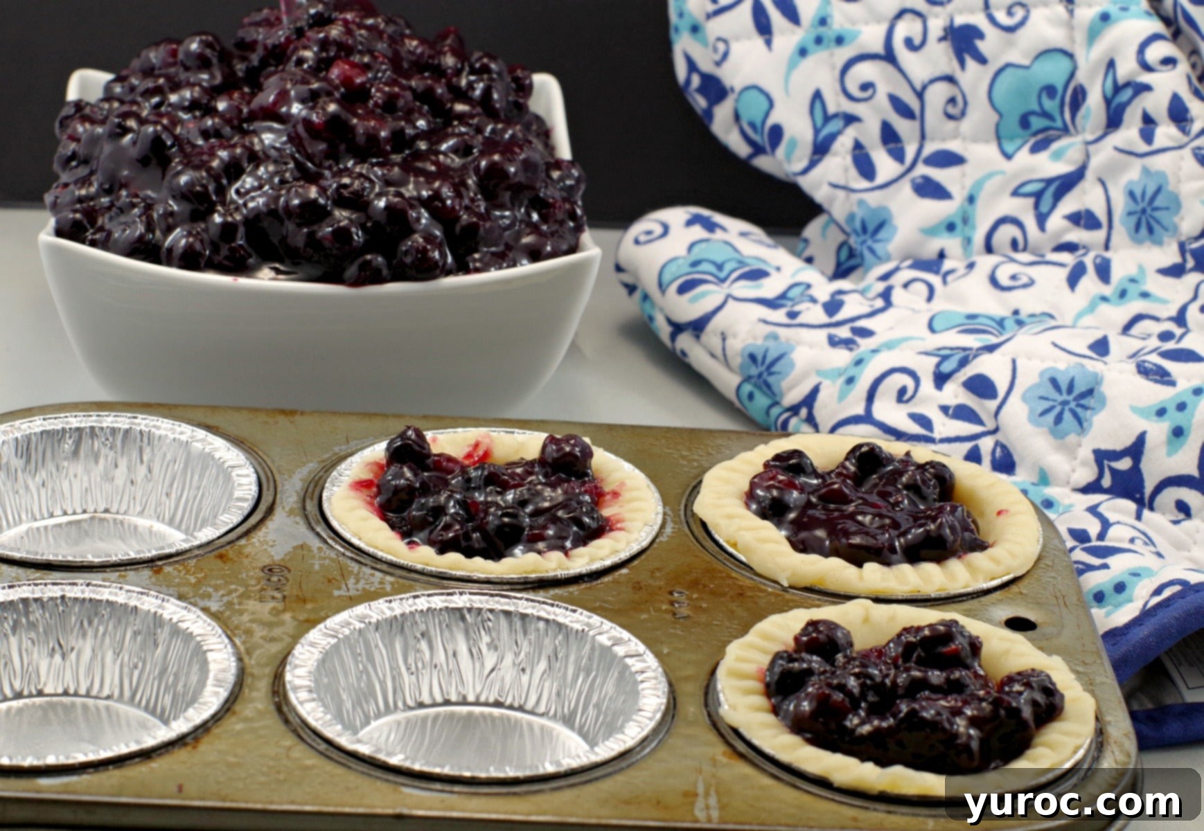 Saskatoon Berry Pie: Mastering the Filling and Sauce 13 Saskatoon berry pie filling in tarts with bowl of pie filling in background
