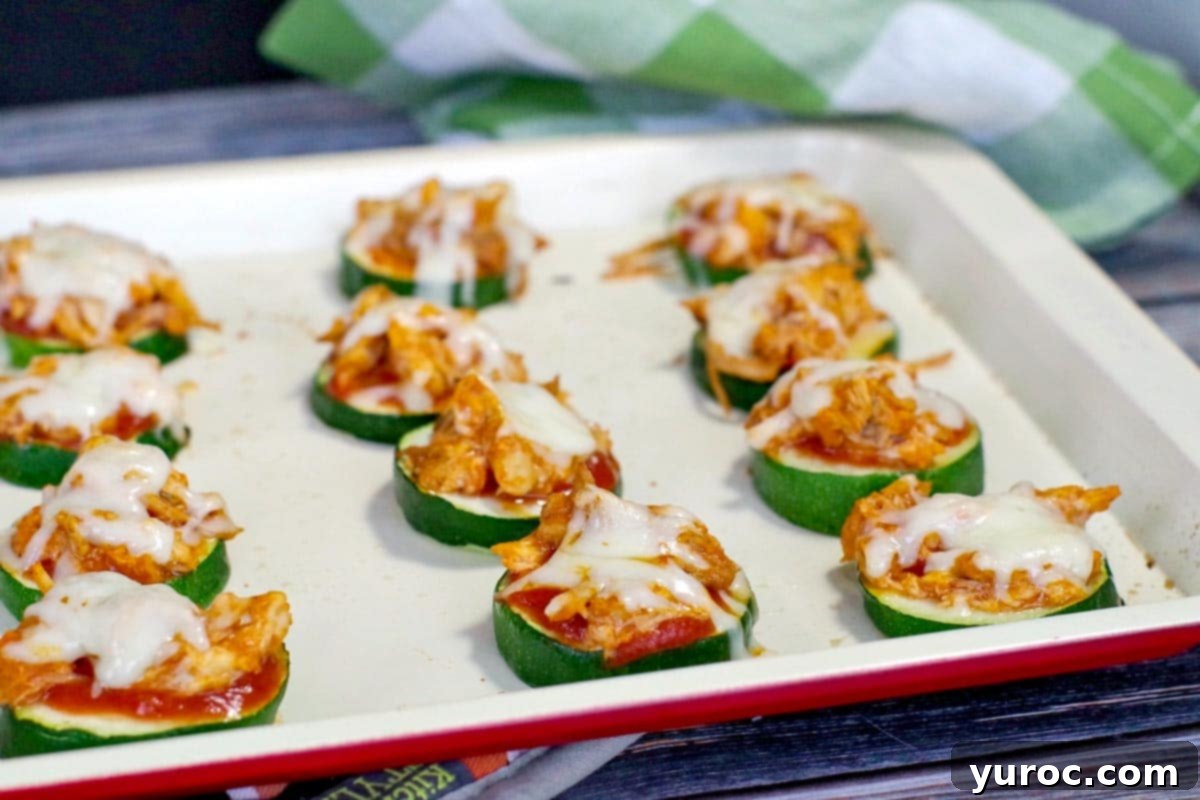 Healthy Buffalo Chicken Zucchini Pizza Bites on a baking tray, ready to be served for game day.