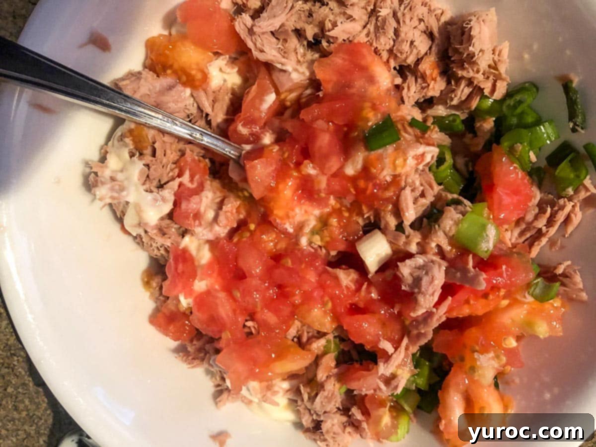 tuna being mixed with other ingredients