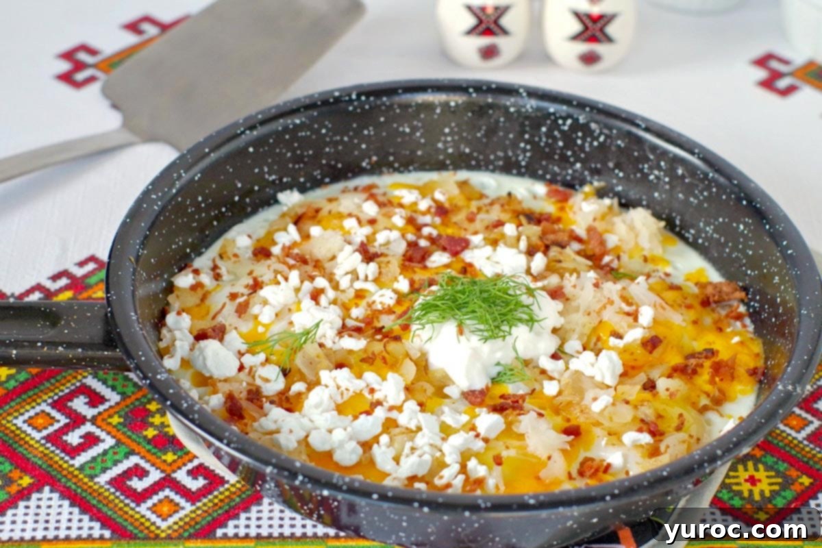 Ukrainian style eggs cooked in a frying pan, ready to serve with toppings.
