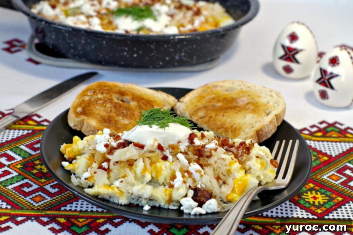 A black plate of scrambled Ukrainian style eggs in the foreground, with a pan of fried Ukrainian style eggs in the background.