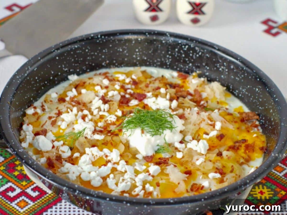 Loaded Ukrainian Style Eggs with toppings served directly in the frying pan.