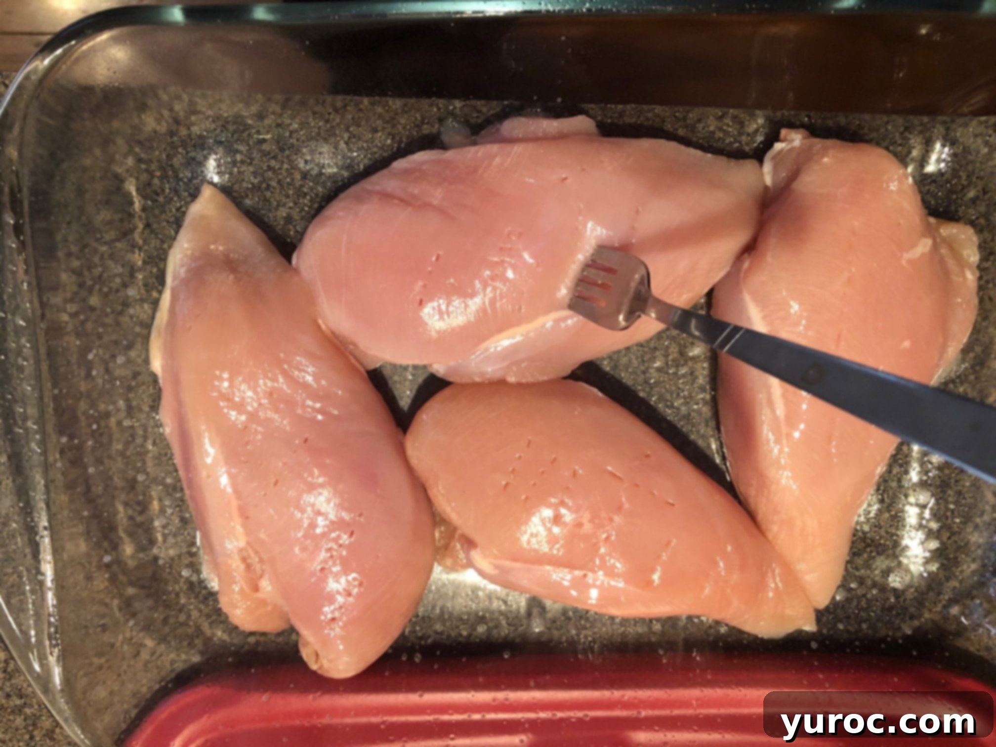 chicken breast being scored