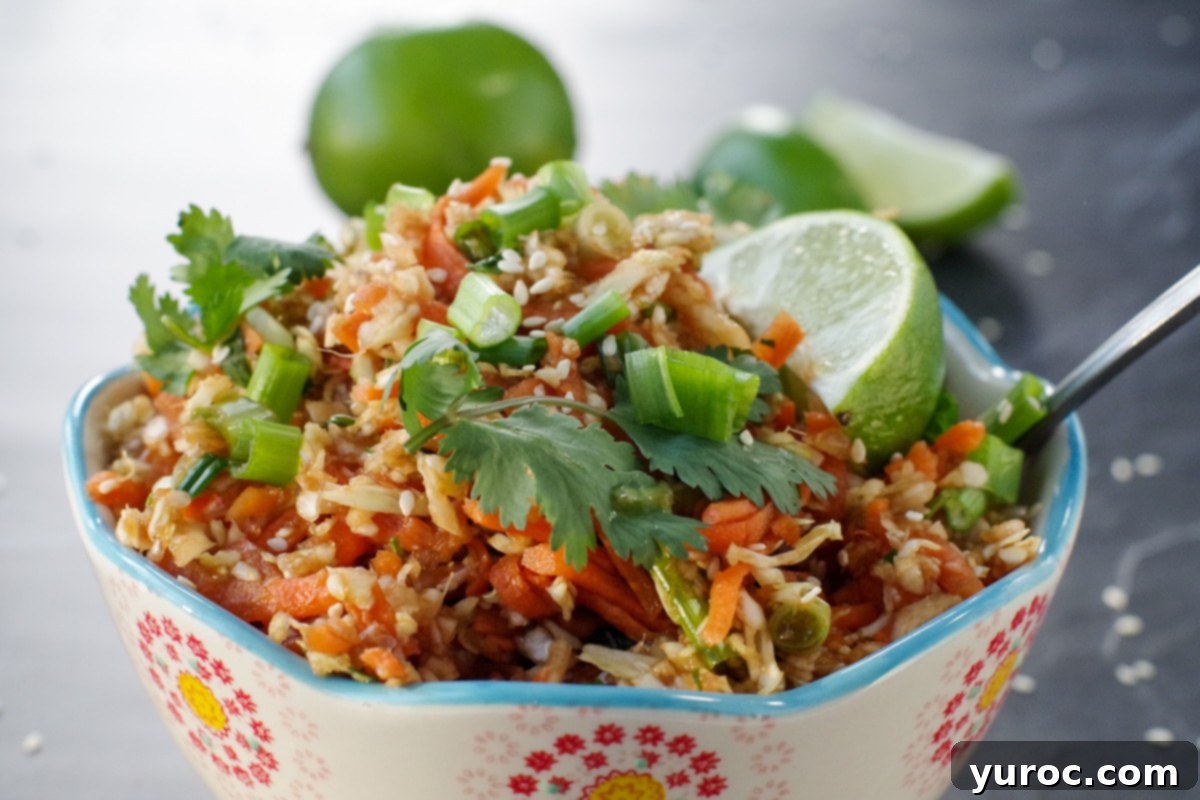Guilt-Free Coleslaw 2 Close-up of vibrant Skinny Asian Coleslaw salad with fresh lime wedges and cilantro garnish