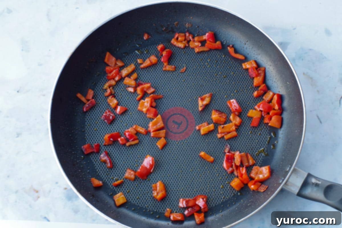 chopped red pepper sauteed in a pan