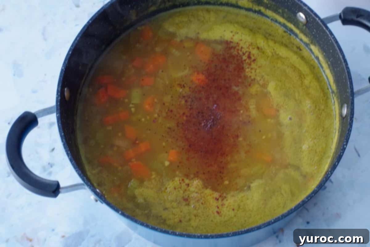 spices and pumpkin added to soup pot
