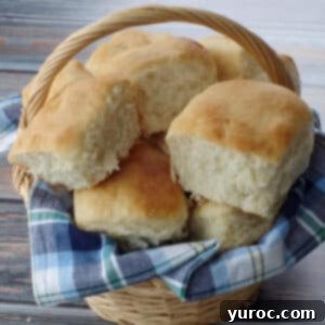 several granny buns in a basket with a blue checked cloth