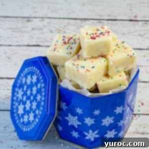 Easy Sugar Cookie Fudge 9 Microwave sugar cookie fudge in blue cookie tin on white faux wood surface