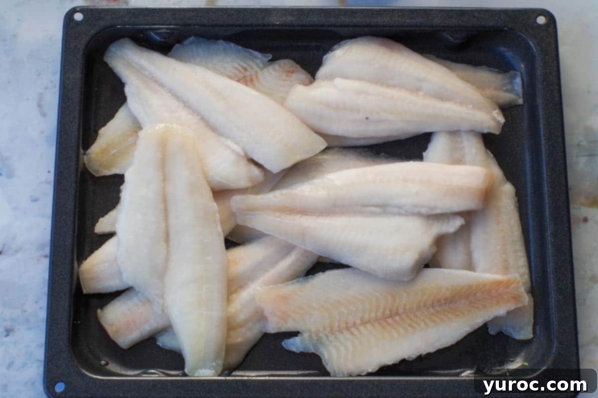 Sole fillets placed in the bottom of a grilling pan, ready for soaking.