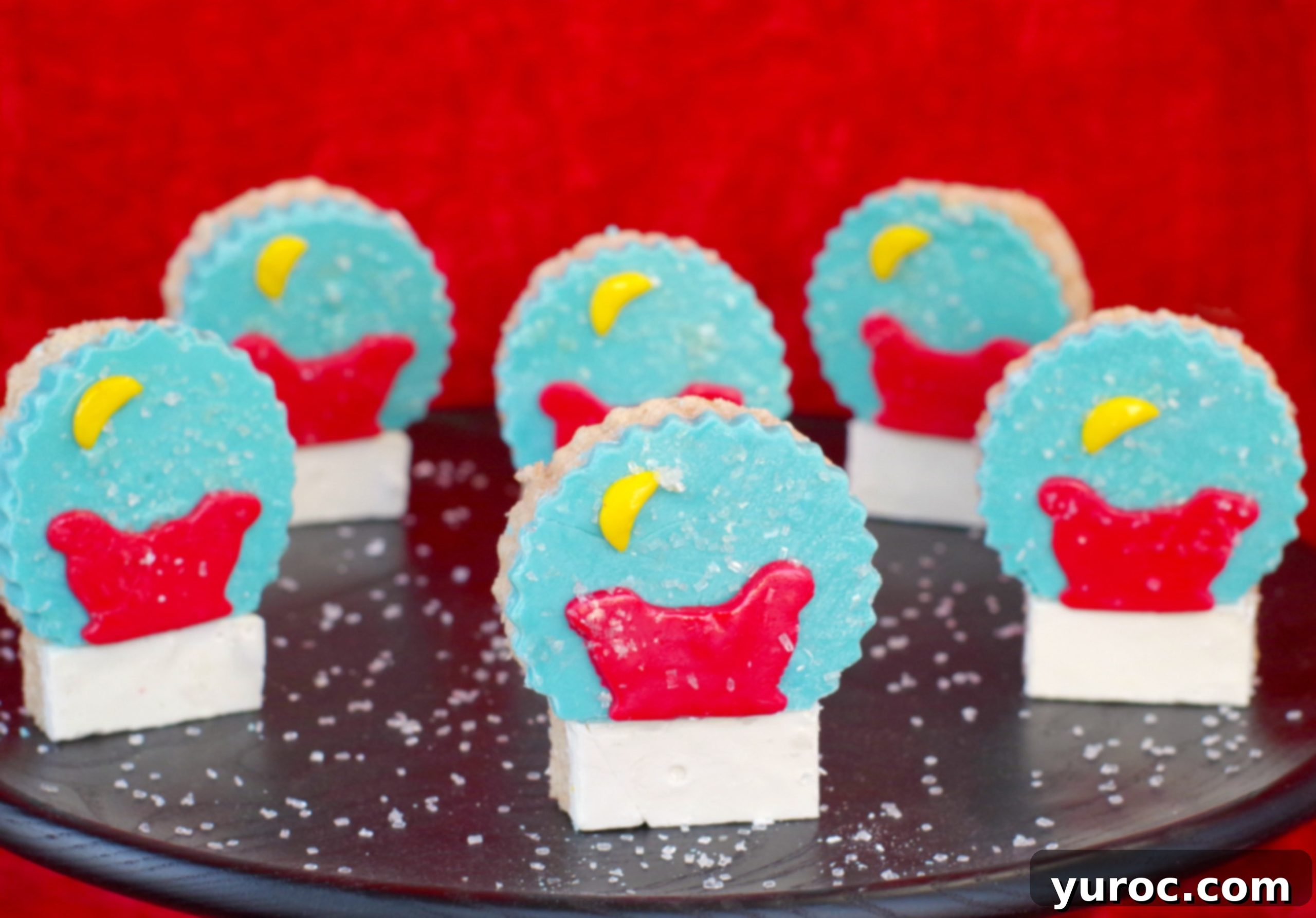 Festive Snow Globe Krispies 2 Festive Snow Globe Rice Krispie Treats on a black serving tray, capturing the holiday spirit.