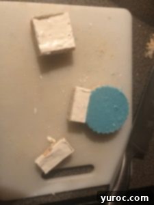 Attaching a white Rice Krispie base to the bottom of a blue snow globe treat.