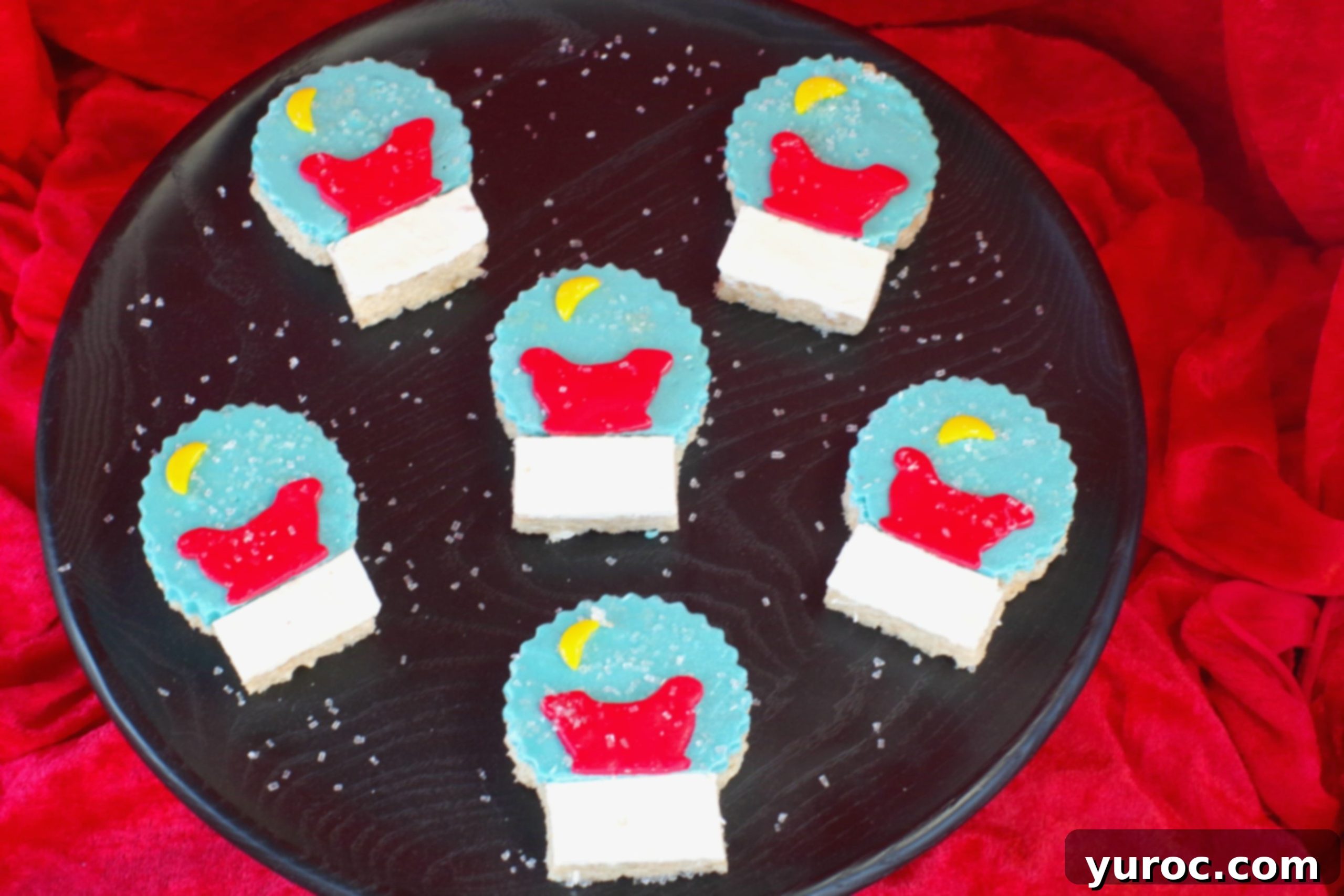 Festive Snow Globe Krispies 7 Snow Globe Rice Krispie Treats elegantly arranged on a black tray, ready for a festive celebration.