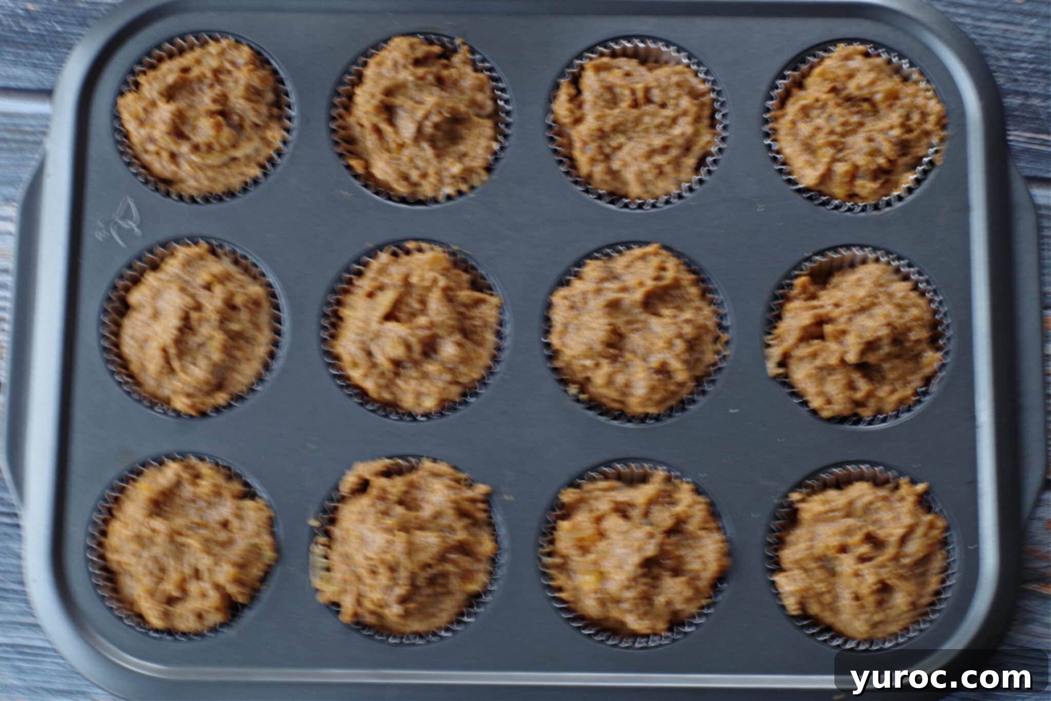 batter filling muffin tins to the top
