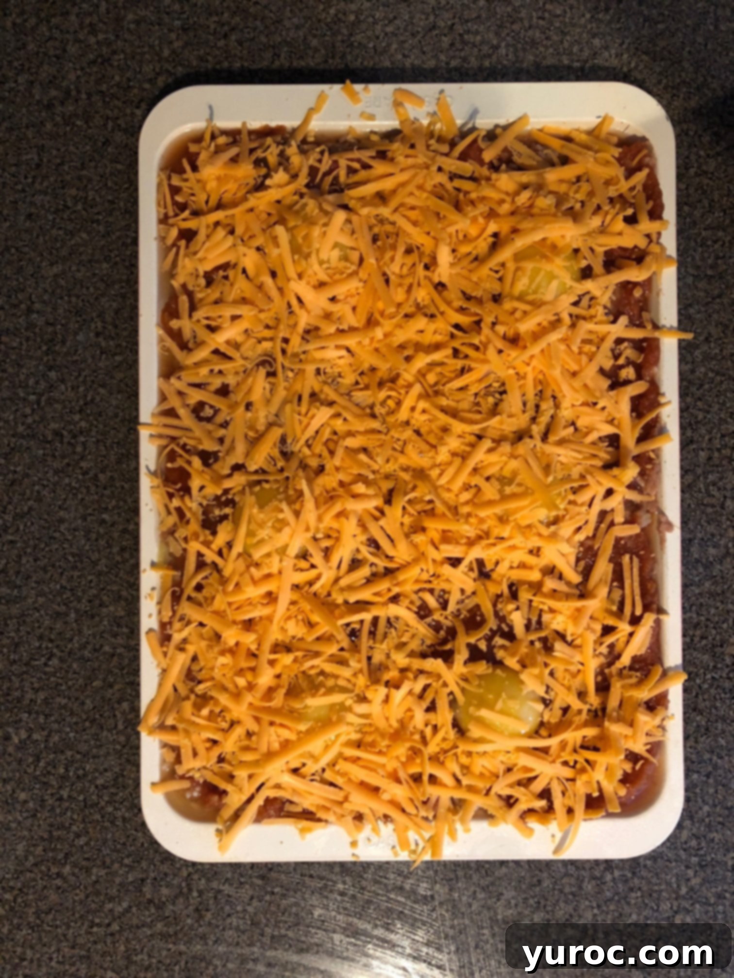 One-Pan Veggie Huevos Fiesta 9 cheese spread on top of tomato sauce to make sheet pan huevos rancheros