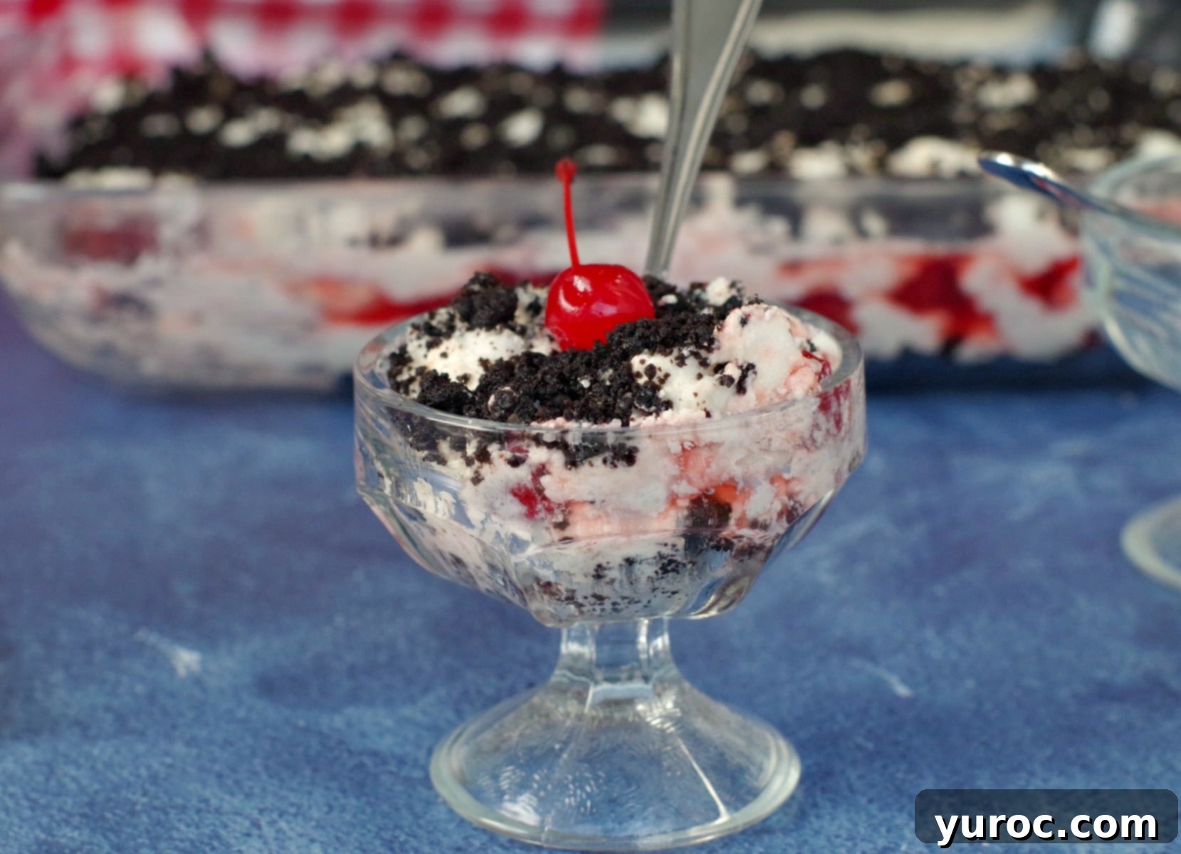 A vibrant Cherry Cha Cha dessert in a glass pan, ready to be served at a family gathering.