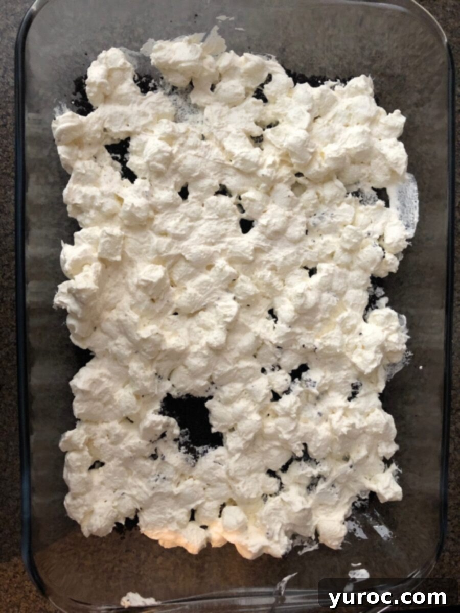 mix marshmallows and whipped cream and add to Oreo crumb layer