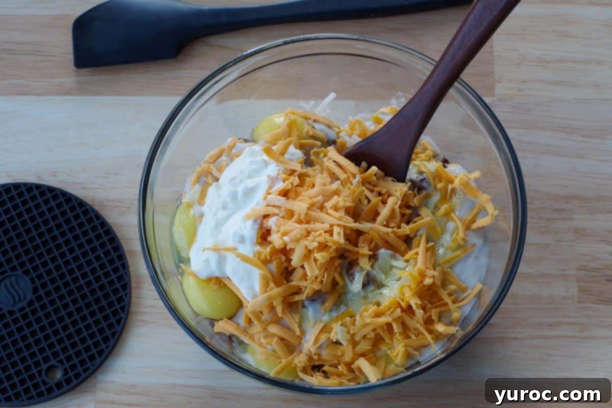 all ingredients in glass bowl with spatula