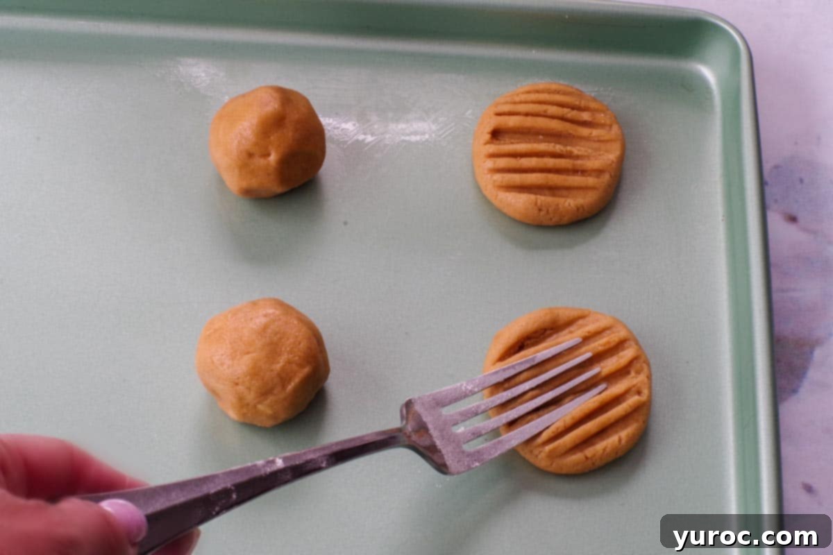 Chunky Peanut Butter and Cookie Butter Cookies 11 flour dipped fork flattening cookie dough balls