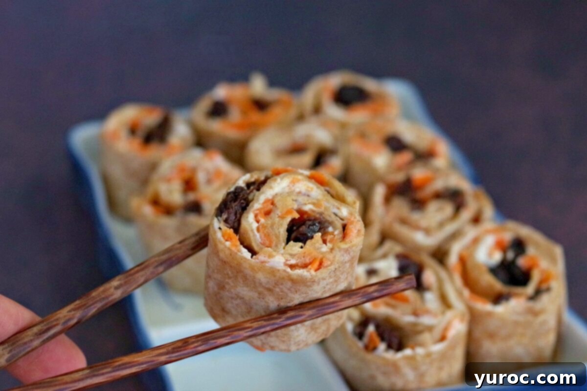 Cinnamon Raisin Tortilla Pinwheels 11 raisin sushi being held up with chopsticks