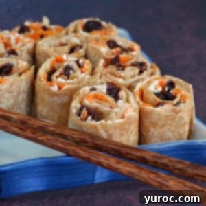 Cinnamon Raisin Tortilla Pinwheels 13 tortilla pinwheels on a blue sushi platter with chopsticks