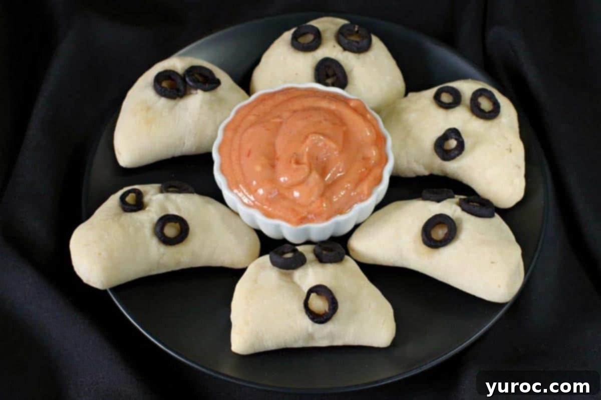 phantom pierogies on a black plate with dip in the middle
