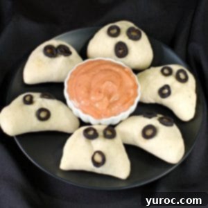 phantom pierogies on a black plate with dip in the middle
