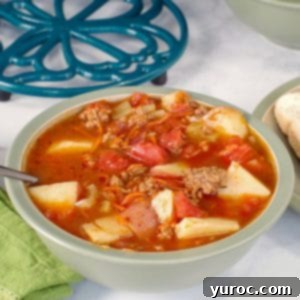 Homestyle Hamburger Potato Soup 10 Hamburger soup in a green bowl with pot holder in background